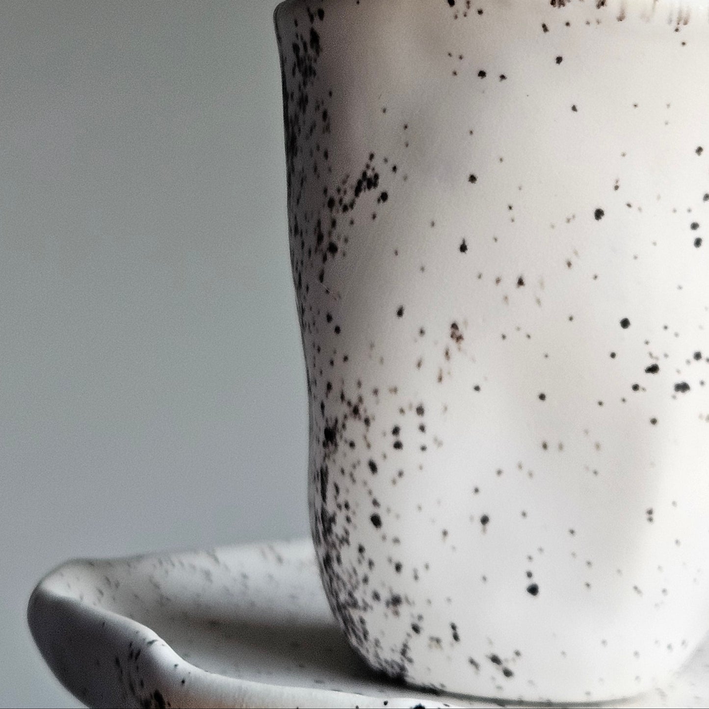 Black white ceramic cup with saucer